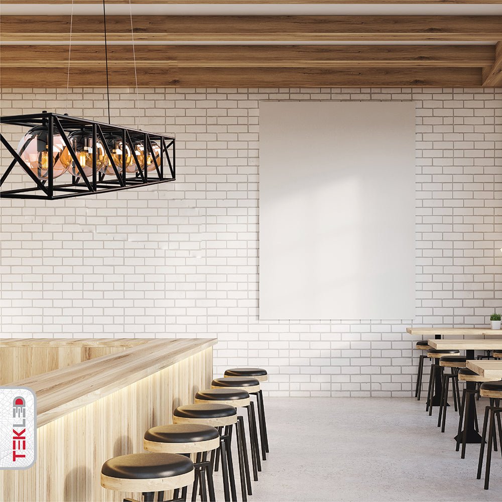 Black cuboid metal cylinder amber glass island chandelier with 5xe27 fitting in indoor setting cafe bar top