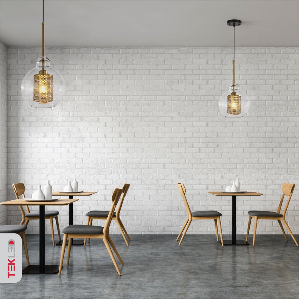 Golden metal clear glass globe pendant light with e27 fitting in indoor setting cafe restaurant